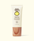 Sun Bum Daily 50 Face Lotion with SPF 50 in a beige tube and wood-textured cap on light background